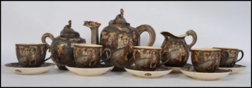 A late 19th /early 20th century Japanese Satsuma Signed Tea Service on black and gilt ground having