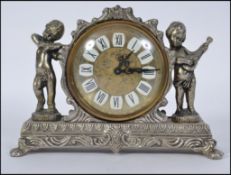 A Small 20th century mantel clock set in a white metal case .