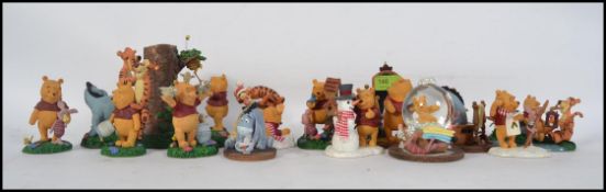 A collection of Disney Winnie The Pooh figures ( 14 ) to include Pooh, Piglet, Eyore, Tigger,