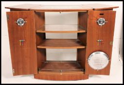 A retro 1970's bow front teak cocktail / drinks cabinet.