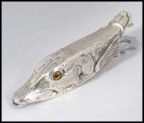 An interesting silver plated paper clip desk tidy in the form a fish