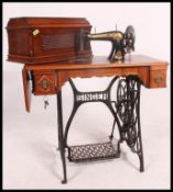 An early 20th century Singer treadle sewing machine raised on typical cast iron base.