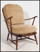 A 20th century Ercol beech and elm wood windsor series armchair raised on turned legs united by