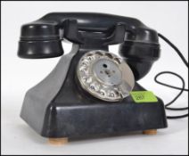 A vintage mid century bakelite telephone having chrome ring dialler and original wiring.