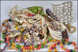 A collection of vintage costume jewellery to include beaded bracelets, necklaces etc,