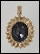 A 9ct gold, diamond and sapphire necklace pendant.