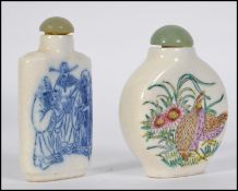 Two 20th century Chinese ceramic snuff bottles both with Jadite stoppers,