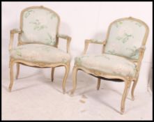 A pair of 20th century louis style French fauteuil / armchairs having padded back,