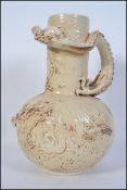 A late 19th century vase by Bretby having long neck with globular body in a pale brown glaze.
