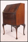A 20th century Queen Anne-style Oak bureau with hinged fall opening to reveal a fully appointed