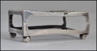 A silver hallmarked matchbox holder of rococo form on bun feet with hallmarks for Birmingham