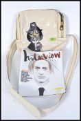 An original Marc Jacobs designer flight bag and a copy of Interview magazine with an interview by
