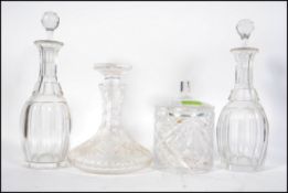 A pair of early 20th century cut glass decanters together with stoppers along with a ships decanter
