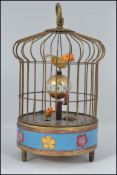 A 20th century Indian brass automaton clock in the form of a bird cage with birds on clock to