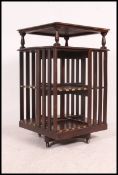 A large Victorian oak revolving bookcase raised on hidden quadruped base with castors.