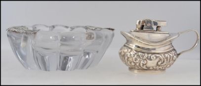 A silver white metal adorned cut glass ashtray together with an automatic table lighter - Musda