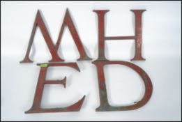 A collection of vintage early 20th century Industrial advertising metal letters to include letters