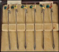 A cased set of six silver hallmarked enamelled cocktail sticks depicting cockerel's in the original