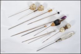 A collection of Victorian hatpins to include gold top ball finial pin along with others