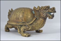 A Chinese brass figurine of a dragon tortoise.