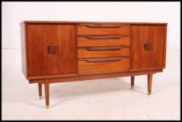 A retro 1970's teak wood small proportion sideboard dresser base raised on tapered legs with