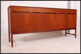A retro 1970's teak Danish influence sideboard raised on tapered supports comprising a series of