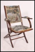 A Victorian mahogany folding campaign - steamer chair of beech construction having tapestry