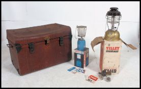 A vintage tin trunk with hinged lid,