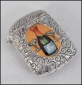 A silver miniature enamel set vesta case of rococo form with applied enamel pictorial panels of an