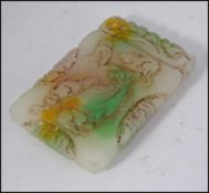 A detailed Chinese carved tablet of mutton white colour with greens being carved all over.