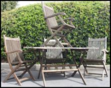 A 20th century large teak garden table together with 4 teak garden chairs H100xW180xD86cm