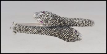 A ladies silver 20th century snake bangle / bracelet with semi-precious stone eyes with safety clip