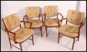 A set of 4 teak and leather Danish influence mid century dining chairs.