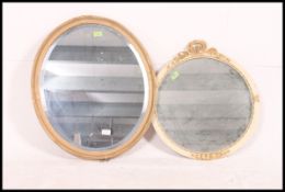 A collection of 1950's gilt framed oval wall mirrors,