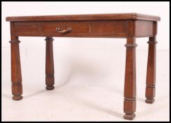 An early 20th century believed Air Ministry oak writing desk raised on squared legs with twin