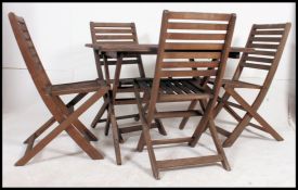 A 1970's teak folding garden table together with a set of 4 teak wood folding garden chairs ( see
