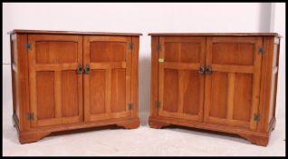 An unusual pair of vintage golden oak pedestal hi-fi cupboards,