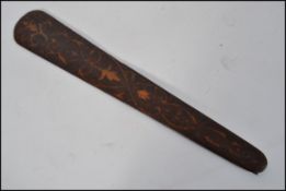 A Victorian poker work page turner / paper knife of tapering form being decorated on both sides