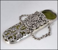A continental silver spectacles case having pierced foliate case with velour lined interior having