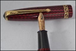 A believed 1960's Conway Stewart 74 ' Speedy-Phil ' red herringbone fountain pen having greek key