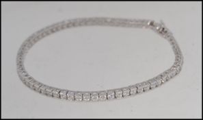 A ladies contemporary silver line set cz bracelet / bangle.