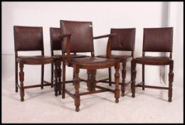 A set of 5 mid century vintage panel back dining chairs having drop in seats being raised on
