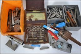 A collection of industrial engineering tools, to include tap and die sets,