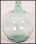 A vintage 20th century large bulbous glass acid carboy bottle with thin waisted neck.