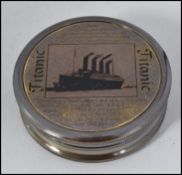 A brass ' Titanic ' style compass set in brass circular case with notation to outer