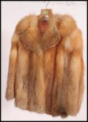 A stunning Fox fur vintage hip length fur coat, having a rich floral satin lining,