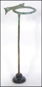 A vintage bronze shop advertising display stand,