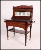 A Victorian Arts & Crafts mahogany and marble washstand having tiled splashback with cupboard to