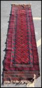 A good 20th century handwoven Bokhara rug / runner with central red ground ,