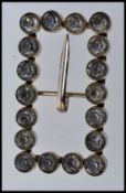 A large early 20th century white metal buckle set with large paste stones with single prong safety